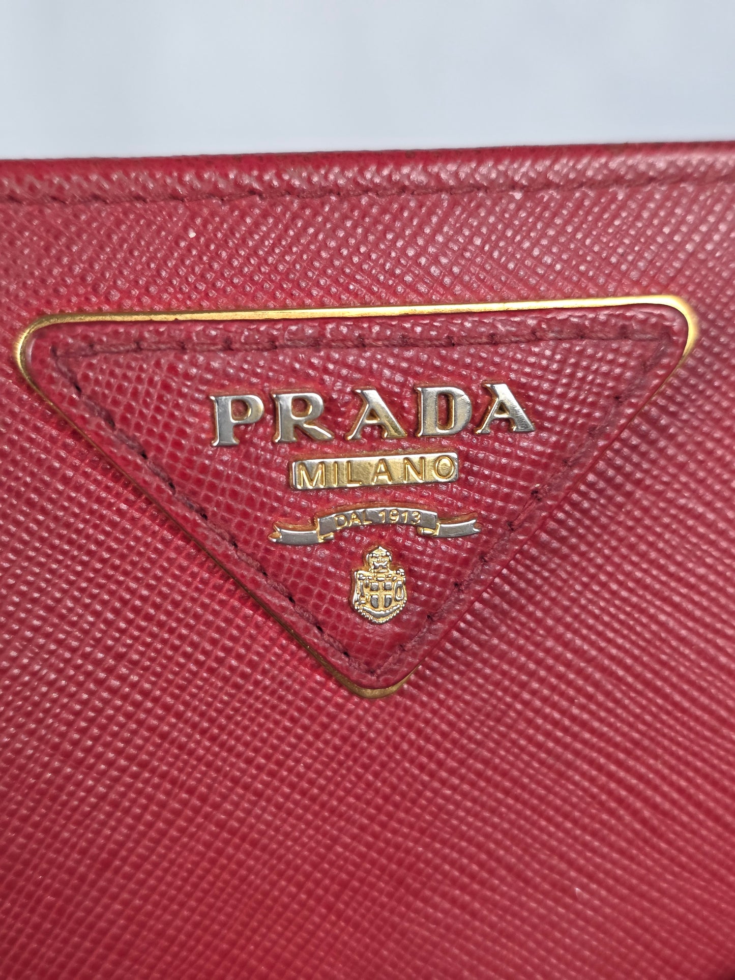 PRADA SAFFIANO RED TRIANGLE MOTIF ZIP/BIFOLD WALLET